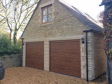 Sectional-garage-door-with-matching-cover-profiles-Centre-ribbed-panel-design-in-Golden-Oak-smooth-finish
